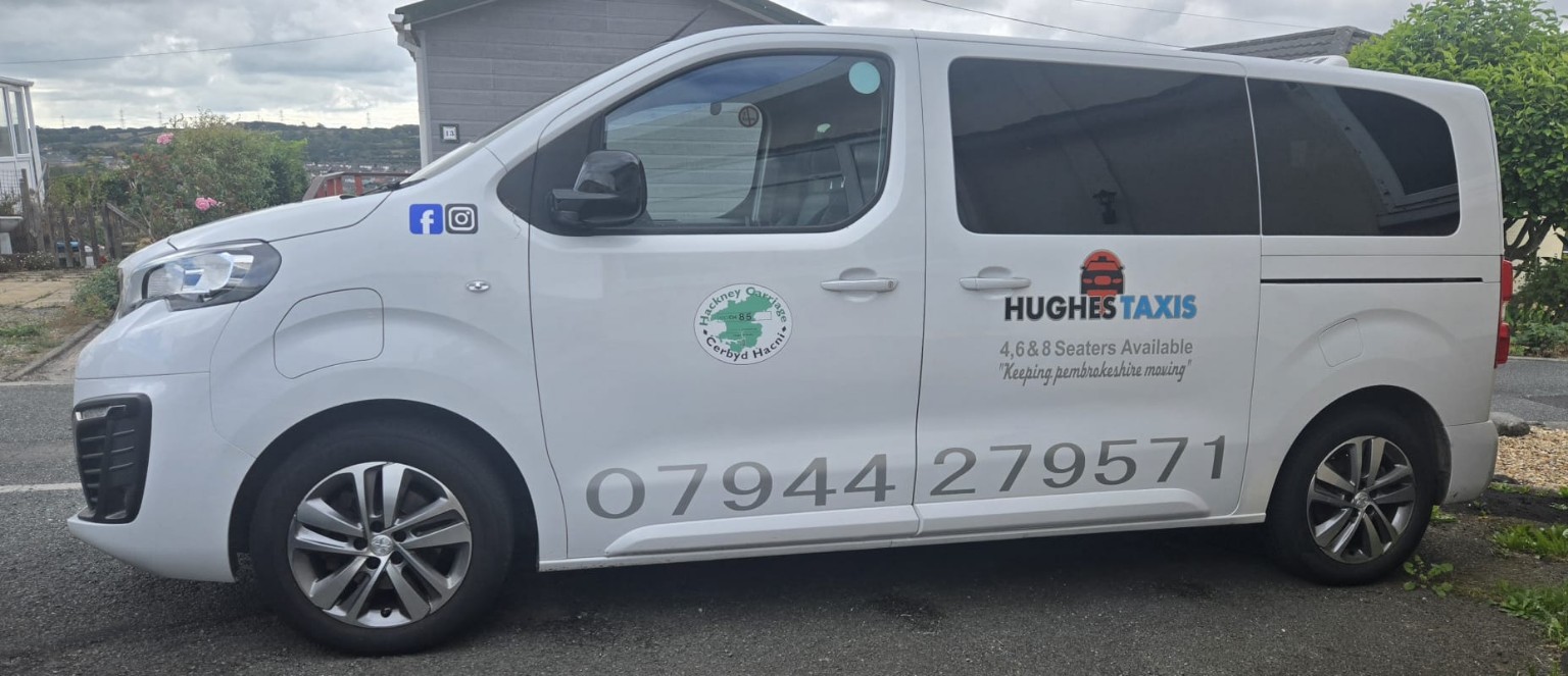 Side view of a Hughes Taxis passenger vehicle